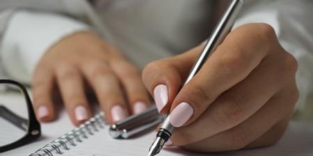 Women writing pro and con list for secured loan 